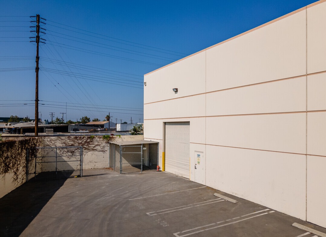 Secured rear yard with grade-level roll-up door