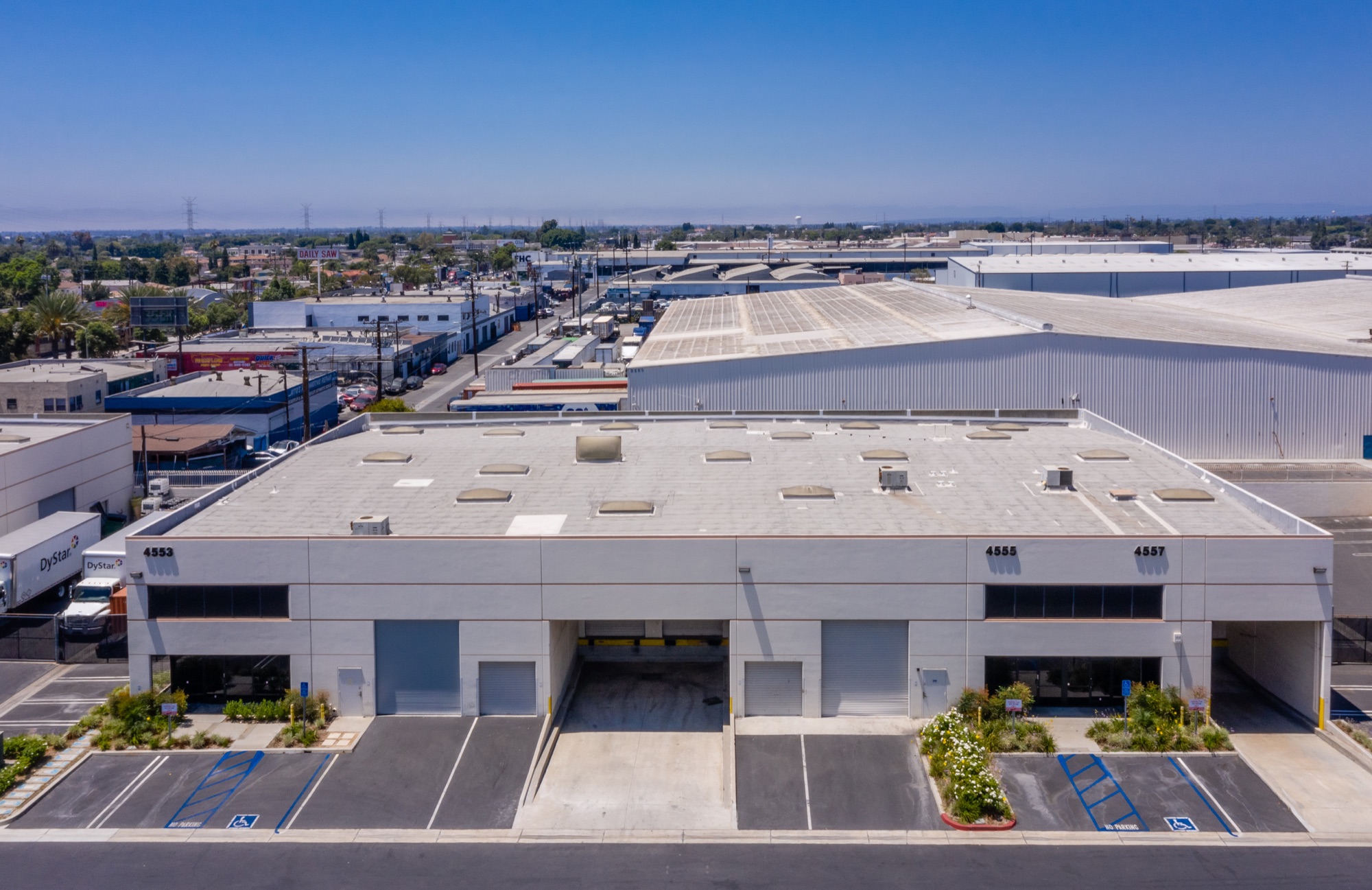 Aerial view of 4553, 4555 and 4557 Firestone Blvd with rooftop and truck court
