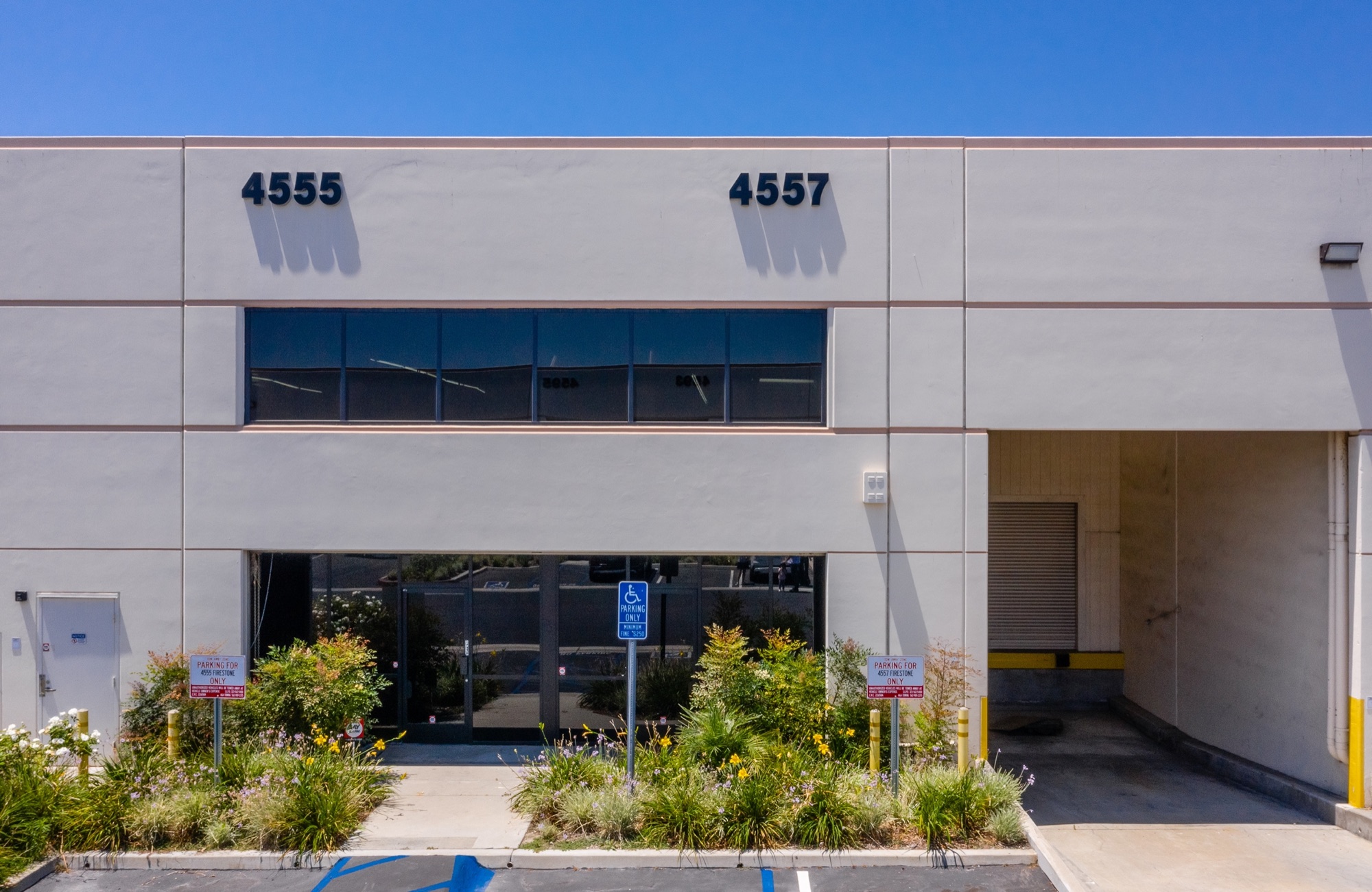 4555 and 4557 Firestone Blvd entrances with landscaped walkway
