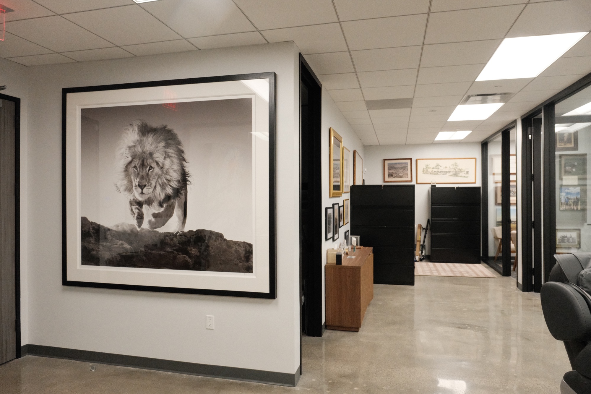 Hallway at the Lyons & O’Brien office with framed art and file storage