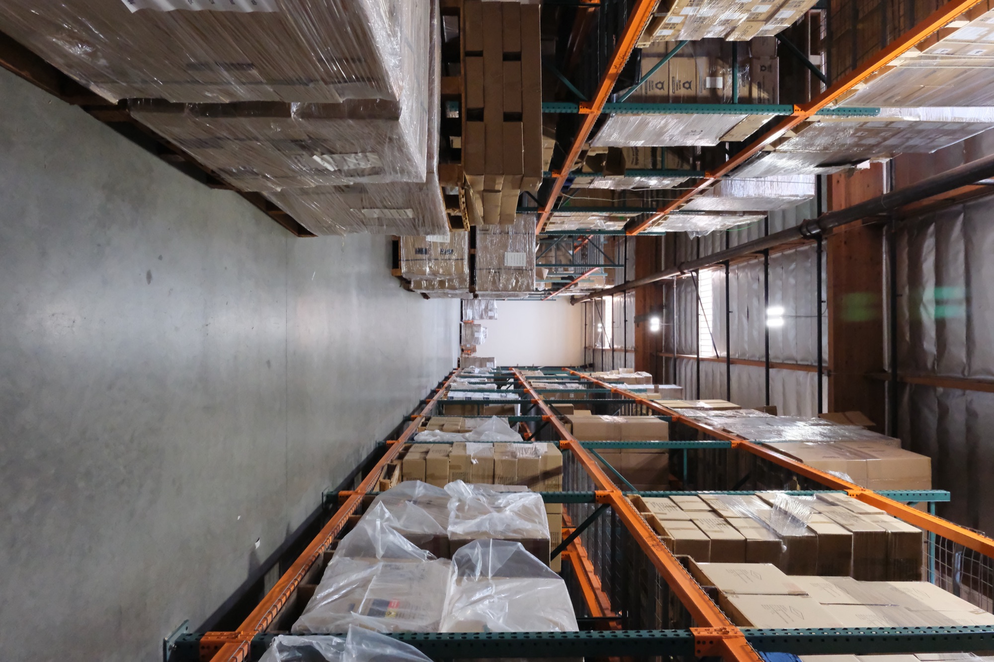 Warehouse aisle with pallet racking stocked to the ceiling along the Garfield Avenue corridor