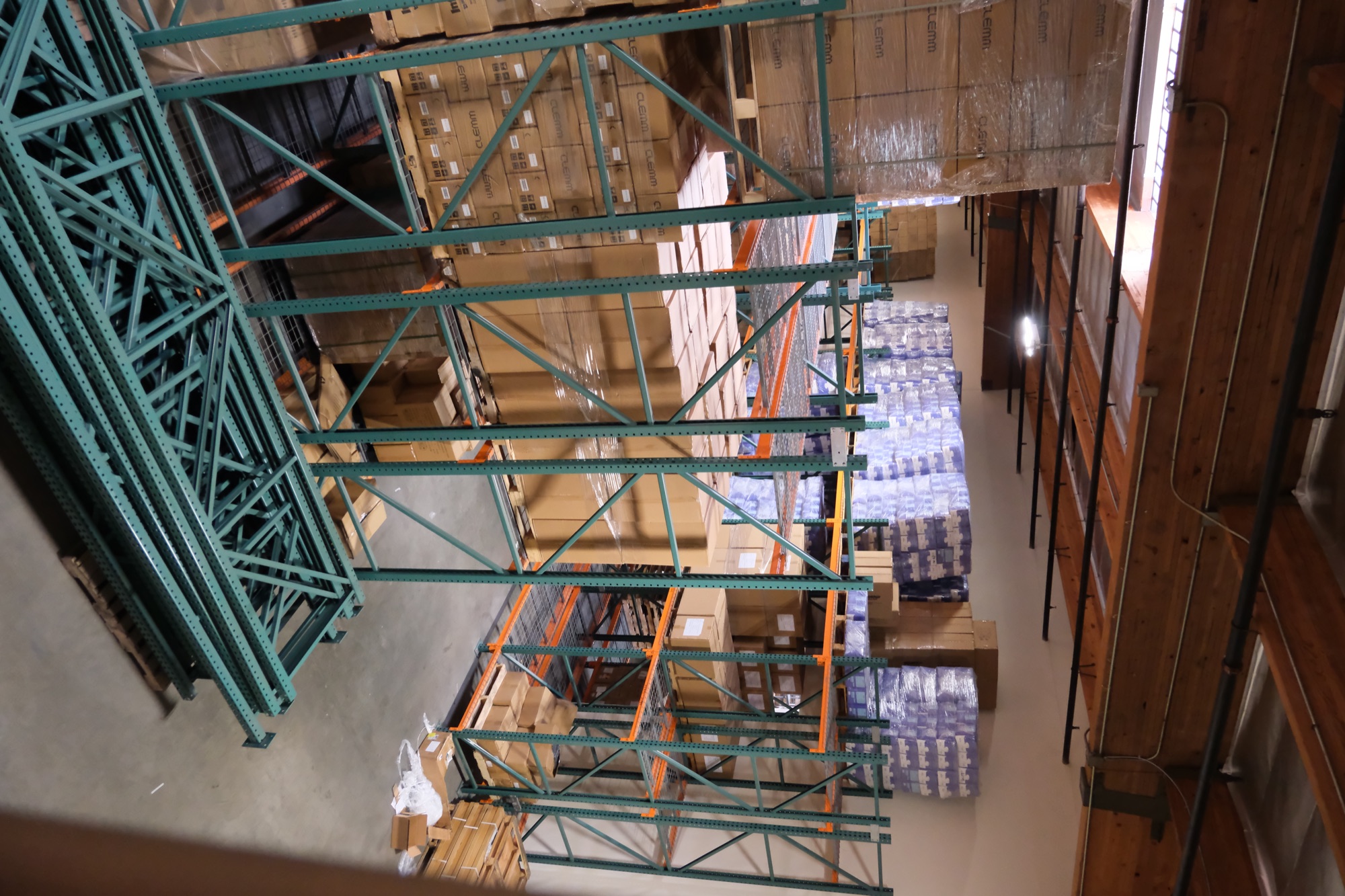 Warehouse interior with green pallet racking and wrapped freight along the Garfield Avenue corridor