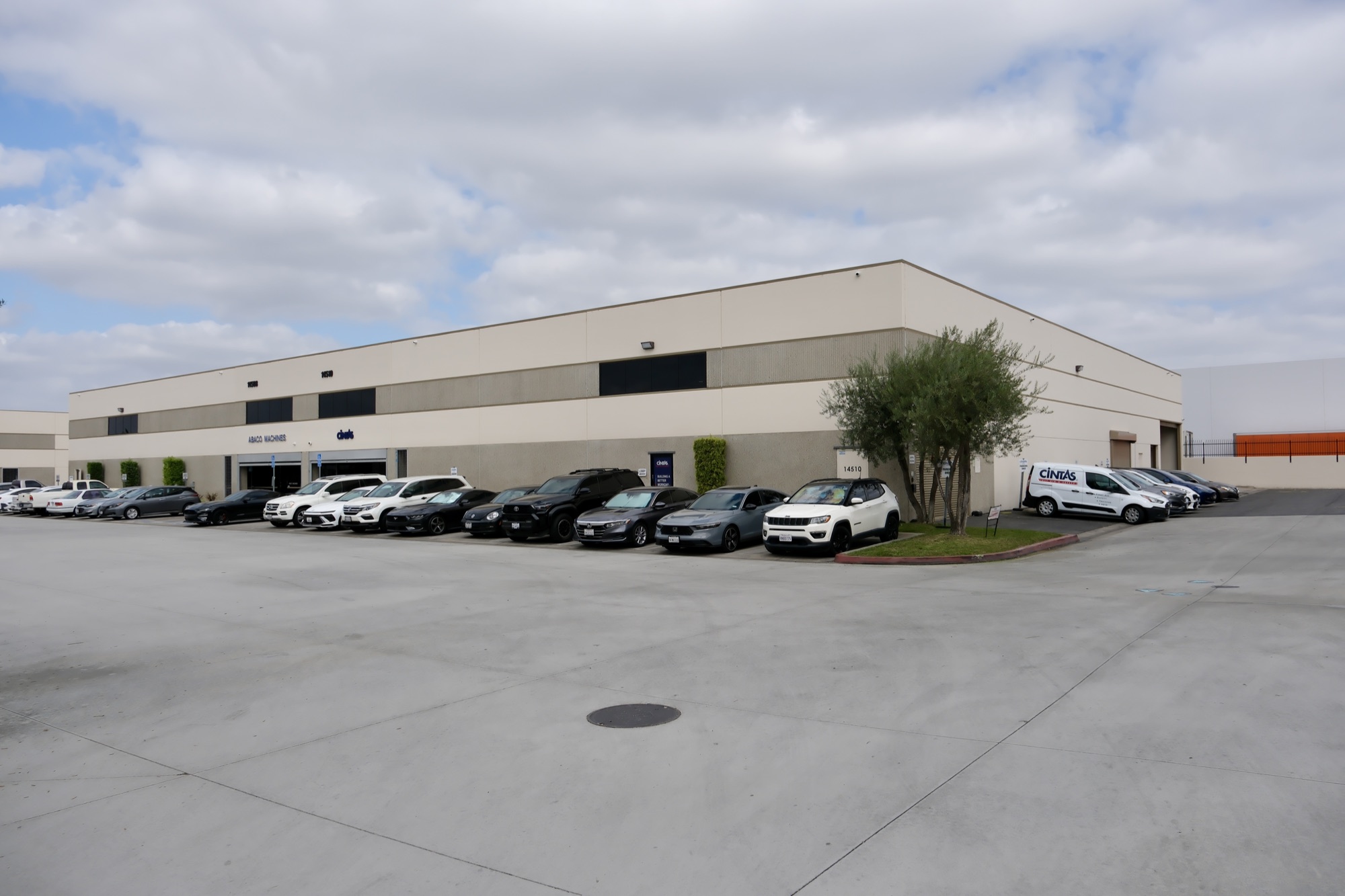 Exterior of 14510 Garfield Ave with Abaco Machines and Civids signage and tenant parking