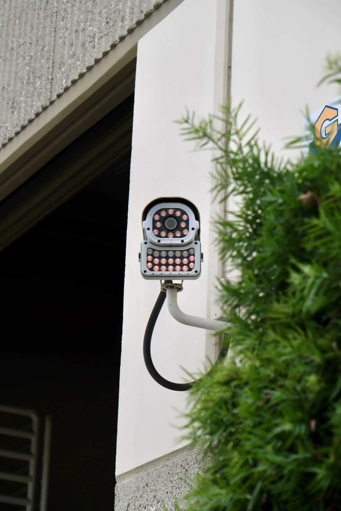 Security camera and speaker mounted at the entrance to a Garfield Avenue building