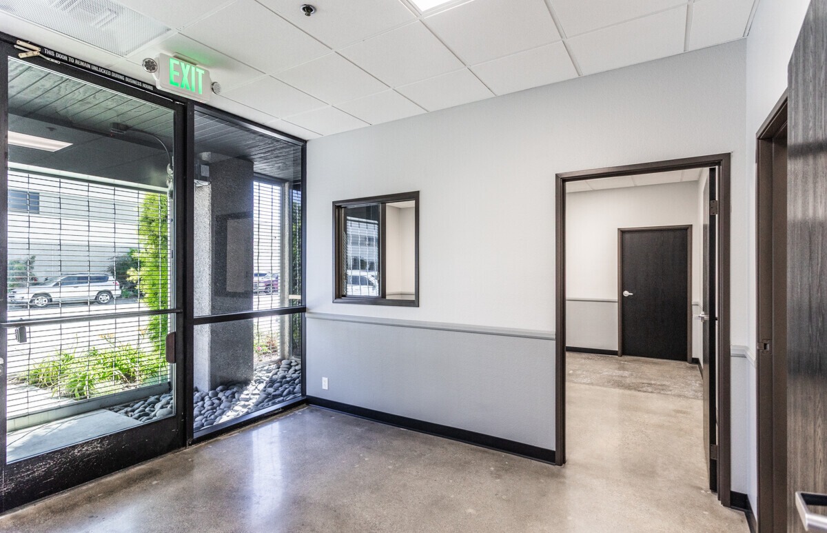 Office entry lobby with storefront glazing and interior offices beyond