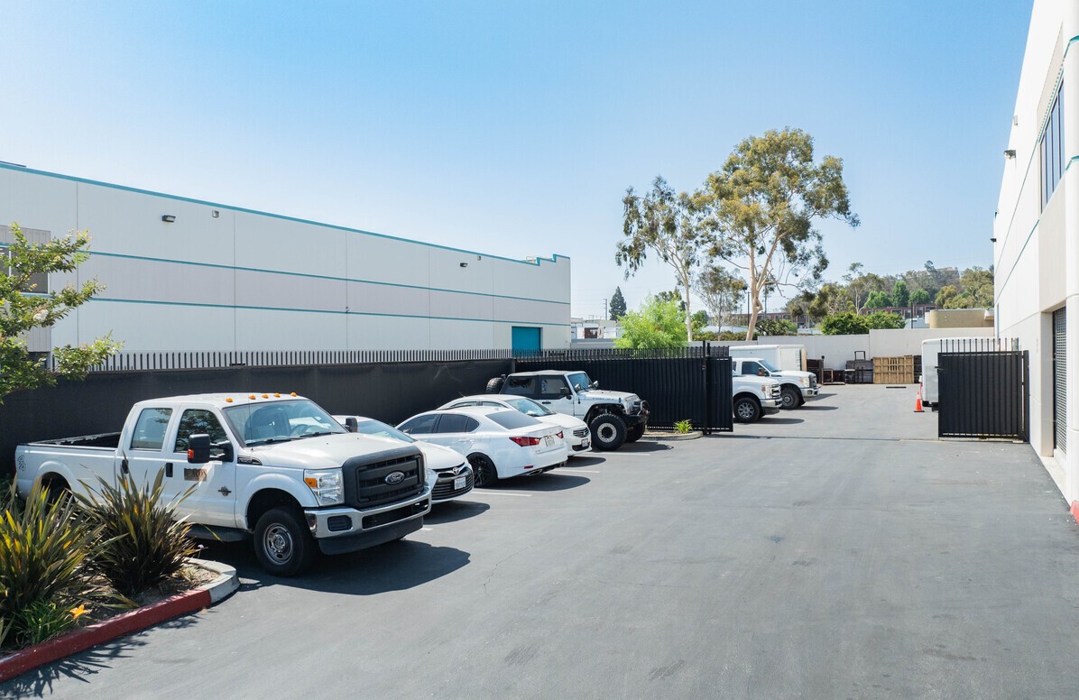 Gated side yard and tenant parking alongside the building