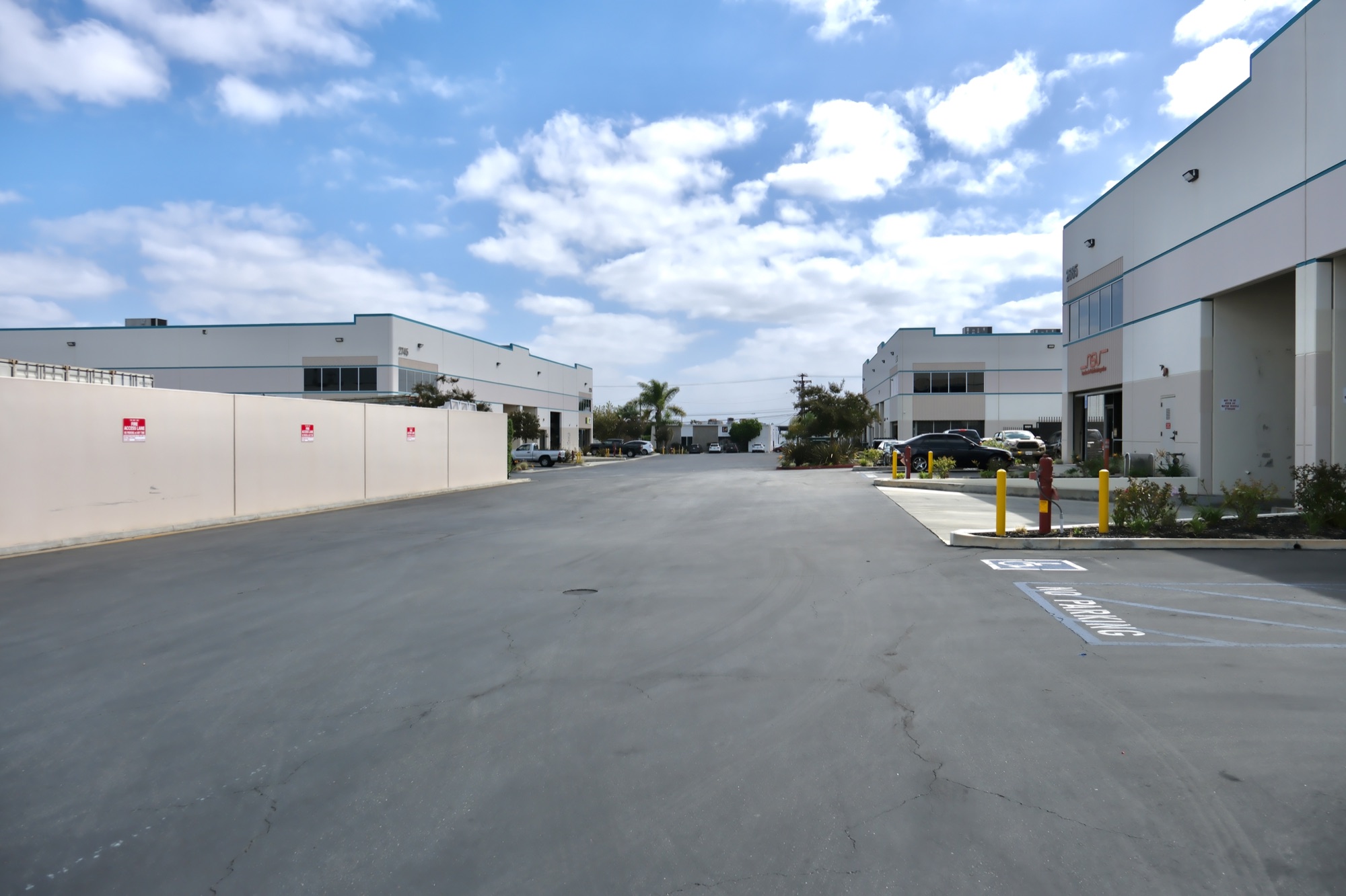 Driveway between 2745 and 2695 Temple Ave with fire access lane and reserved parking