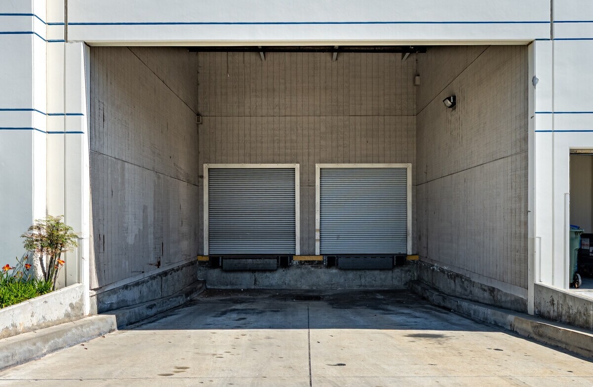 Recessed truck well with two dock-high roll-up doors and levelers