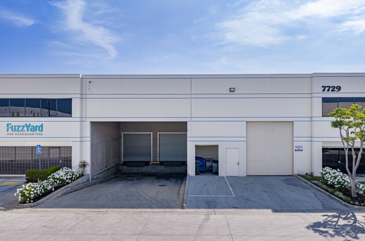 7729 Somerset Blvd elevation with recessed dock doors, grade-level door and landscaping