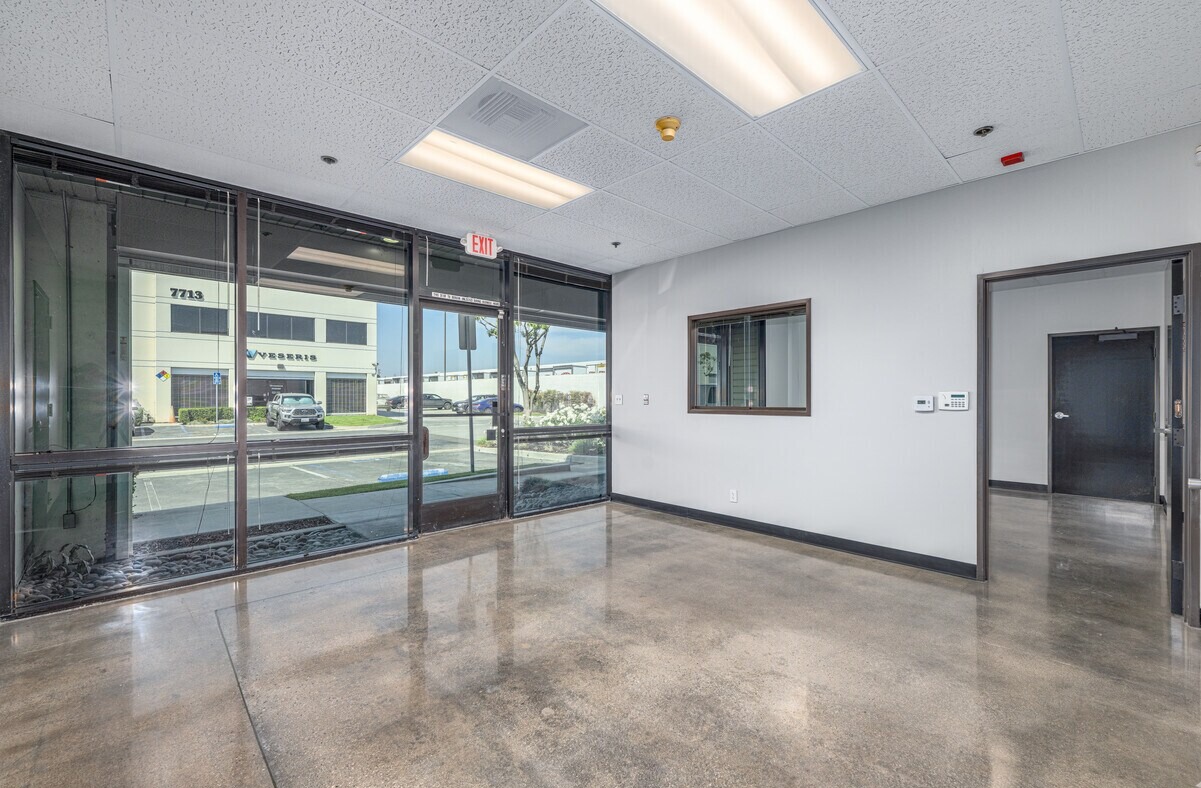 Office entry lobby with storefront glazing and polished concrete floor