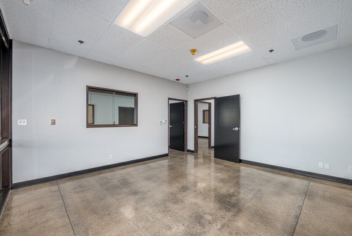 Private office with interior vision panel and polished concrete floor