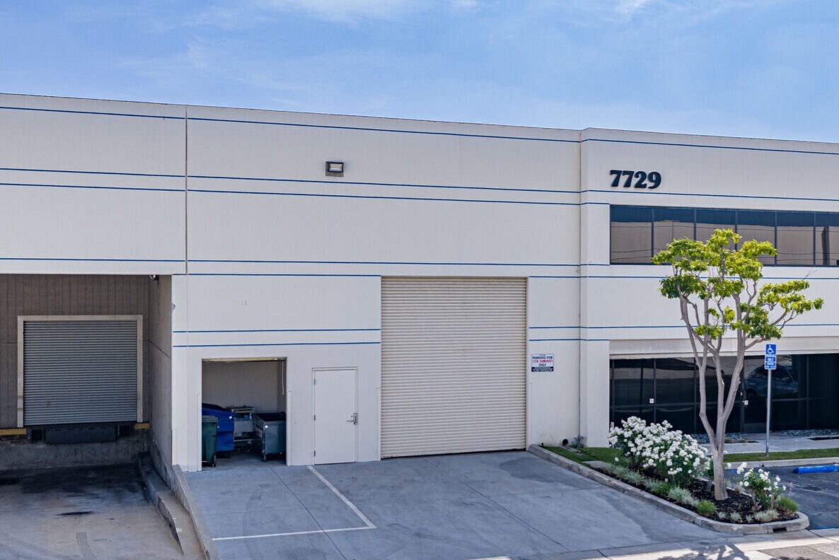 7729 Somerset Blvd rear elevation with grade-level roll-up door and recessed dock loading