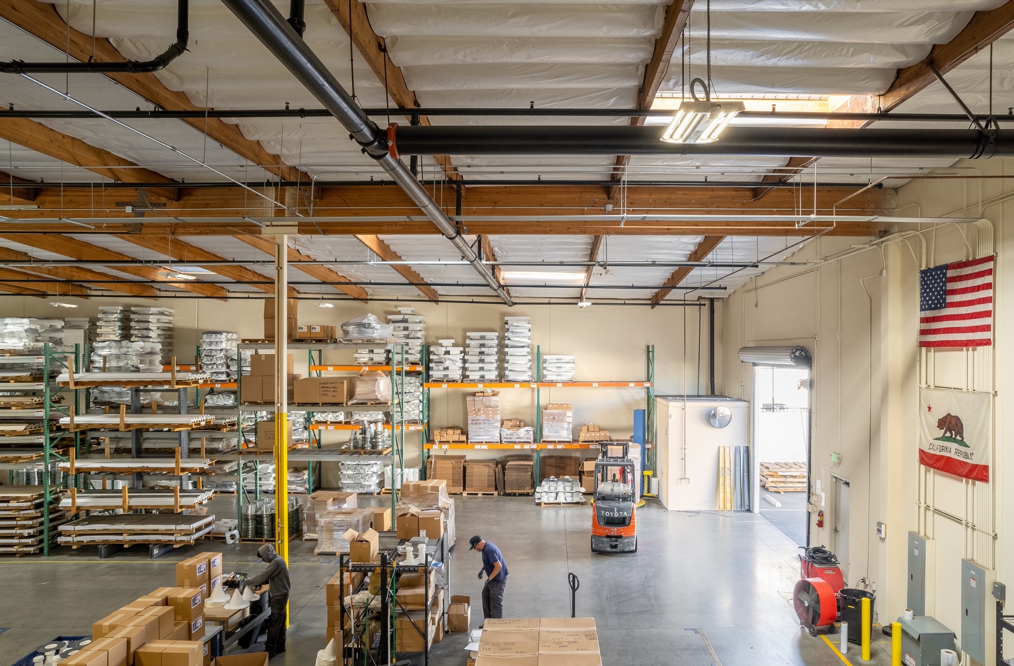 Warehouse interior with pallet racking and wood truss ceiling