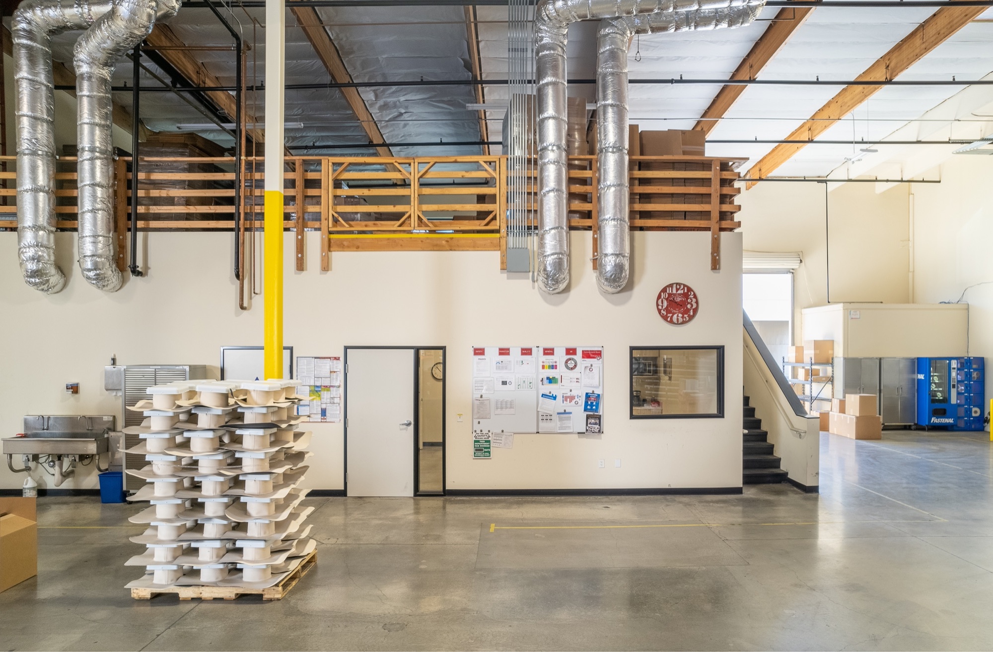 Warehouse interior with office mezzanine and stair access