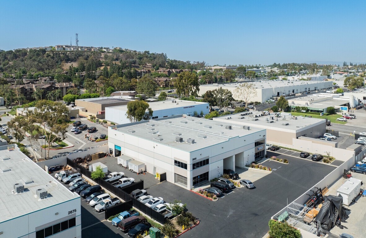 Aerial view of the 2695 Temple Ave building in Signal Hill, California, with its truck court, tenant parking and the Signal Hill ridge beyond